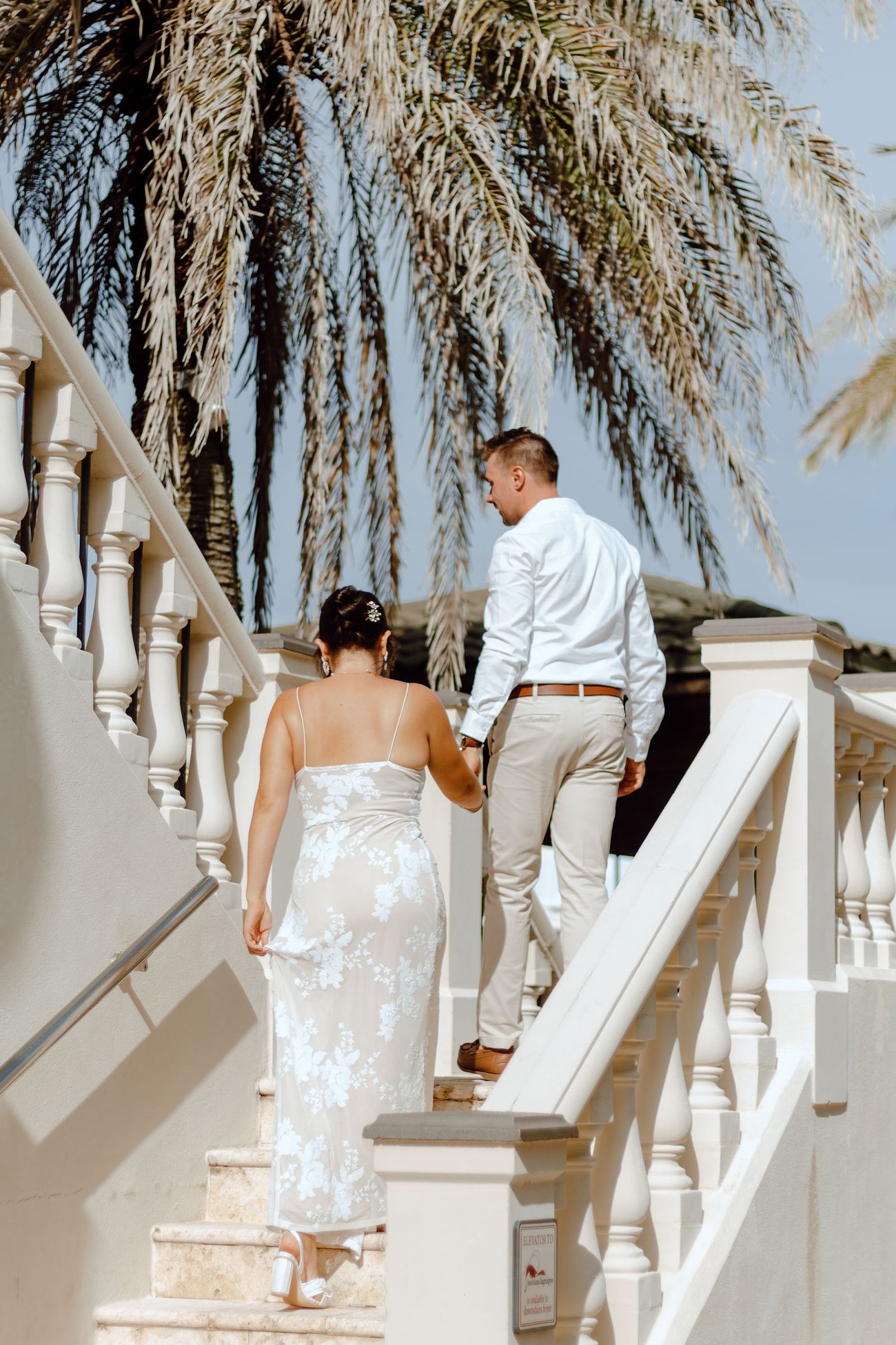 Climbing the staircase under the palms