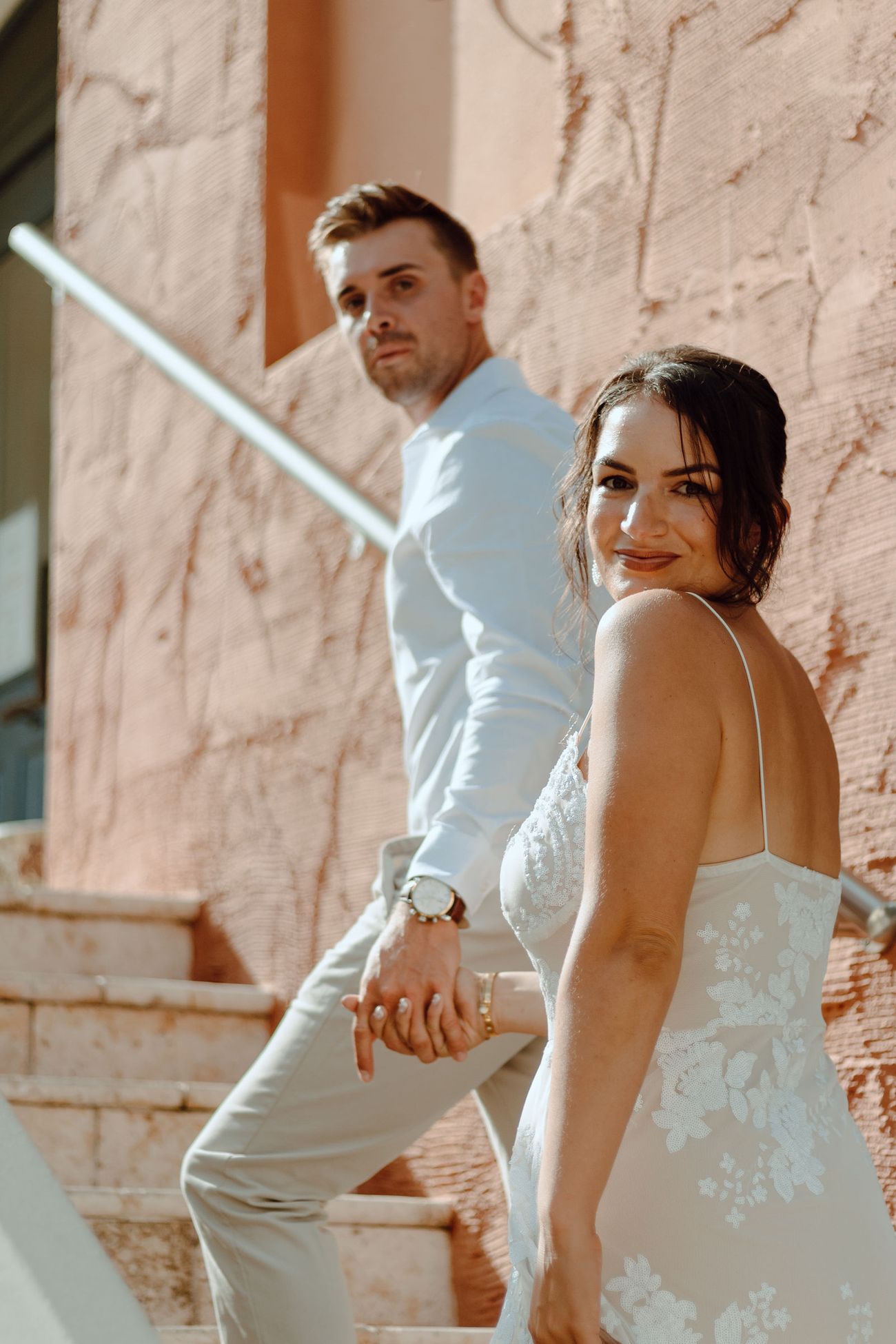 Alex and Kelsey on the stairs by the coral wall