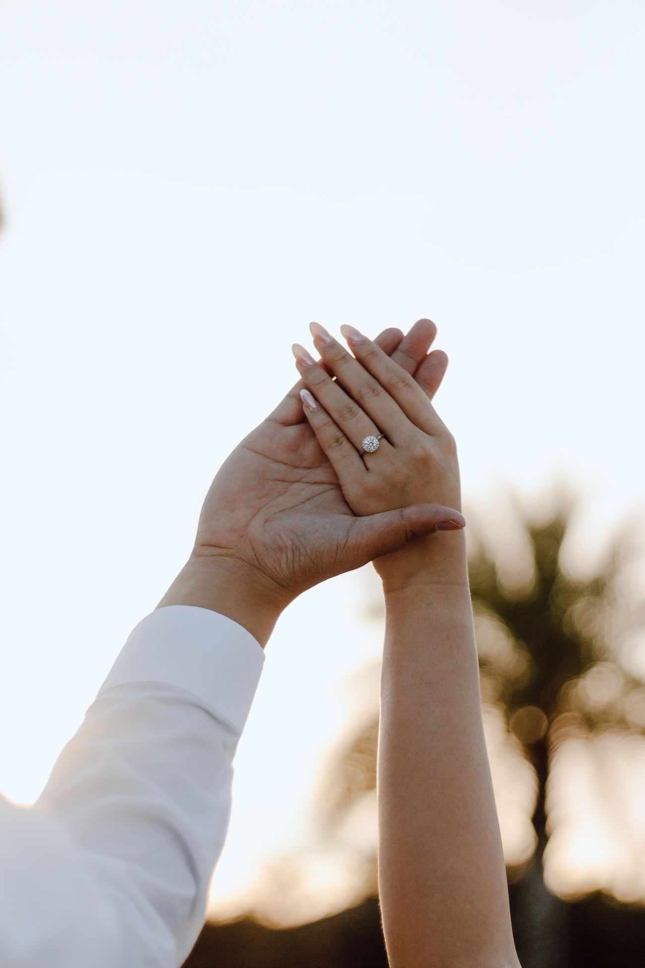 Her hand up to the sky, ring on