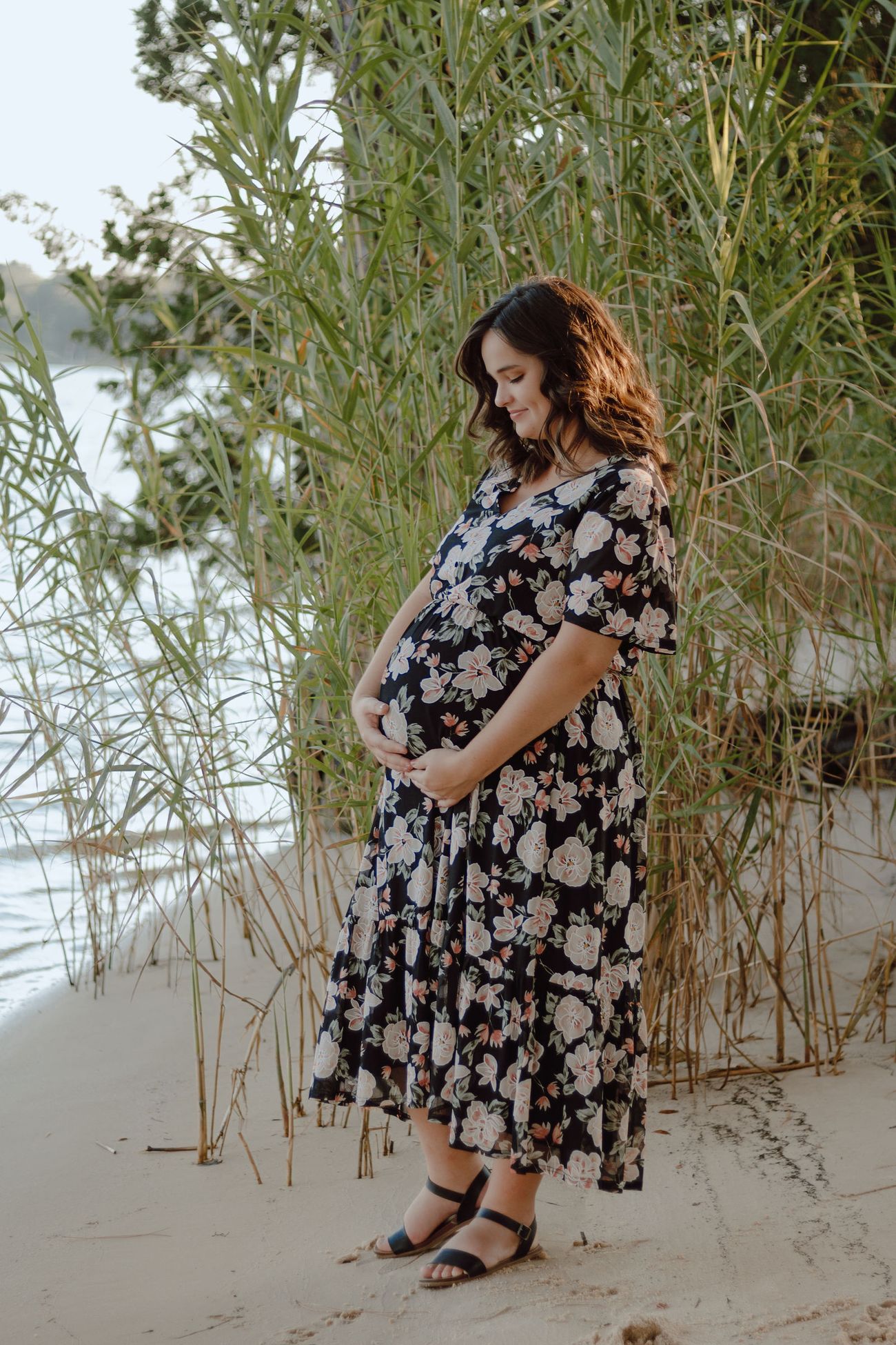 Hands on her belly in the reeds